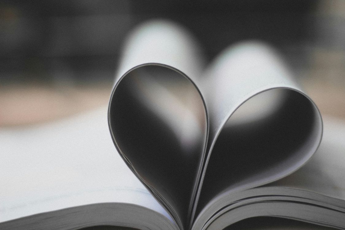 Open book pages in the shape of a heart.